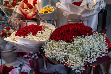 Beautiful flower arrangement featuring red roses and baby's breath for special occasion in a floral...