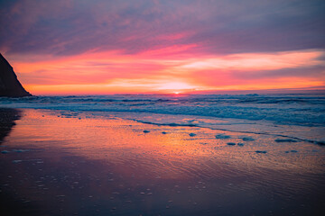 Scenic Sunset Over the Ocean with Waves Washing the Sandy Shore