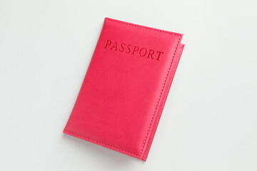 Passport in red cover on light background, top view