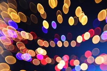 Blurred view of colorful lights on dark blue background, bokeh effect