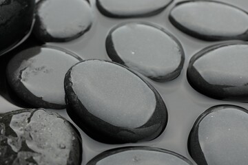 Many spa stones in water, closeup view