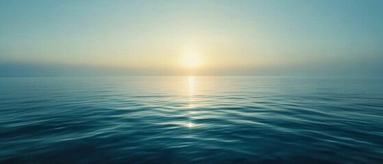 Obraz premium Sunrise reflecting off ocean waves on horizon, soft light and mist