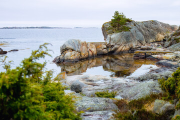 Rugged coastline with cliffs and horizon, slow travel in outdoor rugged beauty. Rocky beaches, quiet reflection and Norway spring, travel magic and slow outdoor exploration. For photography workshops