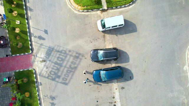 Aerial drone pan up reveal showing midway rest area pitstop on the side of the busy delhi mumbai expressway with massive parking, green parks and multiple cars parked in front of the assortment of