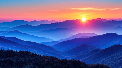 Obraz premium Vibrant sunset over layered blue mountains. Ideal for travel, nature, and serenity themes; evokes peace and tranquility.