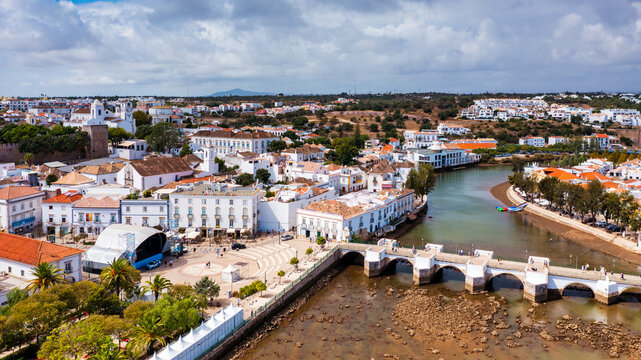 View on historic town of Tavira with Roman bridge over River Gilao, Algarve, Portugal. Cityscape of the Tavira old town with Clock tower, St Marys church, Algarve region, Portugal.