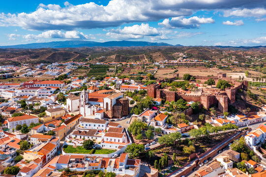 View of Silves town buildings with famous castle and cathedral, Algarve region, Portugal. Walls of medieval castle in Silves town, Algarve region, Portugal.