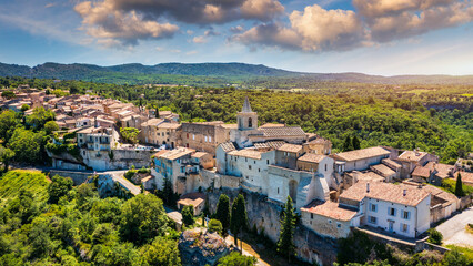 Fototapeta premium View of Venasque village with old church Notre Dame de Vie to landscape of Luberons, Provence, France. Beautiful Church and houses in the town of Venasque, Provence, France.