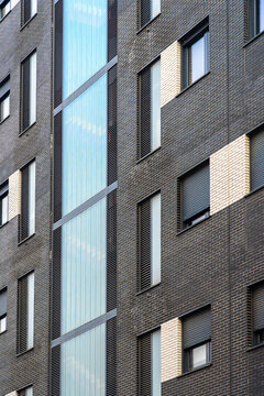 Modern urban building with distinctive brick and glass facade