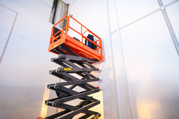 Hydraulic lifting platform on the construction site of an industrial building