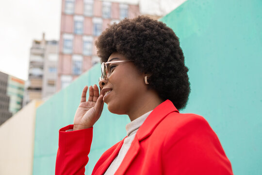 Stylish woman in red embracing urban fashion confidently