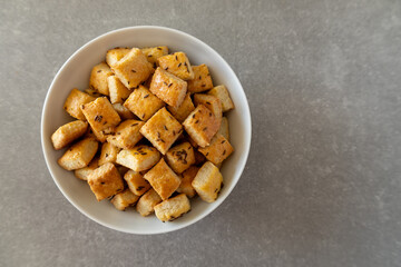 Homemade cottage cheese biscuits with caraway seeds in a white bowl, top-down view.