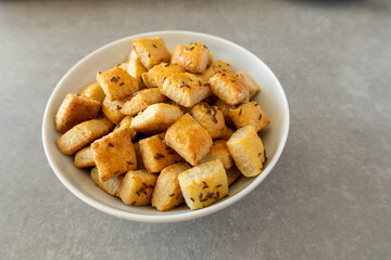 Homemade cottage cheese biscuits with caraway seeds in a white bowl.