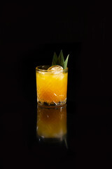 Orange cocktail on a black background.