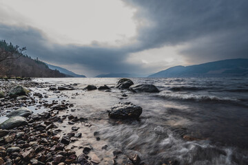 Rocky Scottish Loch Shoreline with Distant Mountains