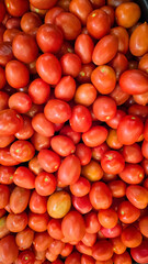 colorful arrangement of fresh, ripe red tomatoes stacked together, showcasing their natural texture and vibrancy, perfect for culinary, market, or agricultural themes.