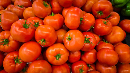 colorful arrangement of fresh, ripe red tomatoes stacked together, showcasing their natural texture and vibrancy, perfect for culinary, market, or agricultural themes.