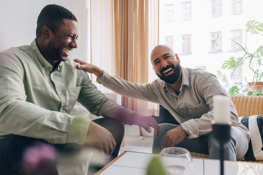 Portrait of happy business professional enjoying break time with male coworker in office