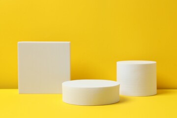 White podiums on a yellow background