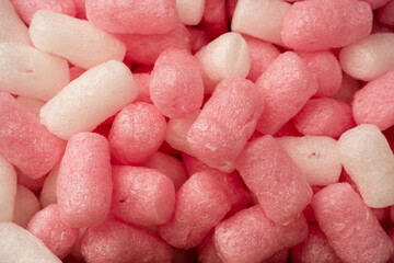 Pink and white box filler as a background. Top view.