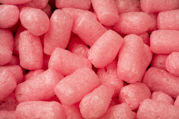 Pink and white box filler as a background. Top view.