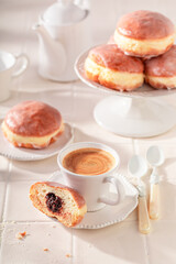 Traditionally doughnuts served with coffee in kitchen.