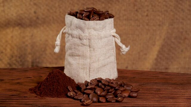 Arabica Coffee Beans Maragogipe in a Bag on a Wooden and Burlap Background with Rotating Effect. Elephant Beans with Ground Coffee