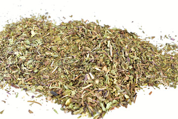 Dry and ground fragrant mint herb lies on a white background.