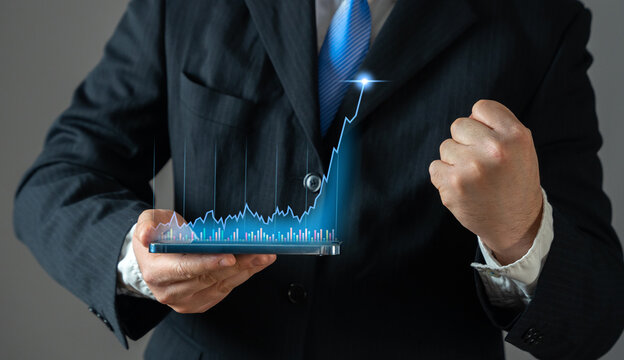 Businessman rejoices in high growth of income and value of trading stocks or cryptocurrency. Concept of success in business. Rising profits, stock market gains, and cryptocurrency value appreciation.