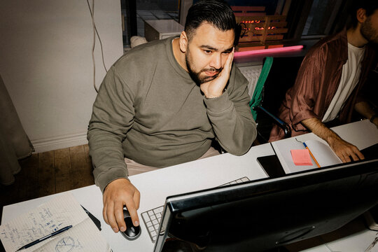 High angle view of male computer programmer working at office
