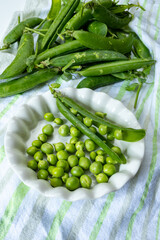 New harvest of fresh ripe green peas legumes