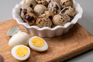 Fresh small spotted partridge or quail bird eggs uncooked and cooked