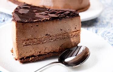 Piece of dark chocolate ice cream frozen cake on board