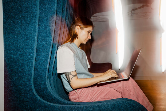 Female entrepreneur using laptop while sitting on seat
