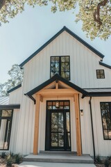 Obraz premium Modern farmhouse design featuring sleek lines and a welcoming entrance with large windows, surrounded by nature on a sunny day