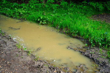 Flooded muddy footpath in the countryside