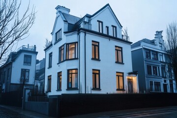 Fototapeta premium A contemporary white house featuring expansive windows is situated in a serene urban neighborhood, beautifully illuminated during twilight hours