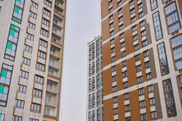 Fototapeta premium Urban Construction A Modern Building is Under Development in the Cityscape Area Nearby