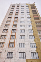 Fototapeta premium Urban Construction A Modern Building is Under Development in the Cityscape Area Nearby
