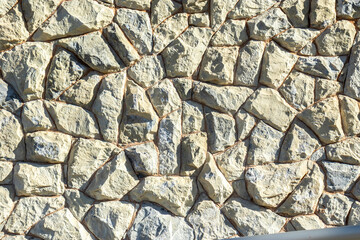 Irregular stone patterns for house walls and fences in Brazil. White stone abstract wallpaper for texture.