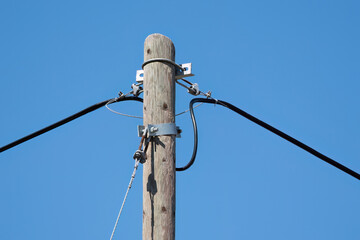 Old type wooden electricity pole, telephone pole.