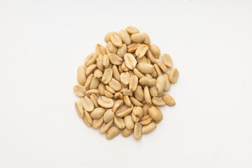 a handful of peanuts on a white table