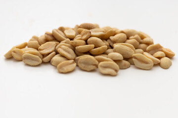 a handful of peanuts on a white table