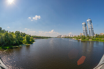 Naklejka premium A modern architectural structure with vertical columns, glass facade, and a riverfront setting is observed The design emphasizes transparency, resilience, and integration of - Kyiv, Ukraine 06-17-2024