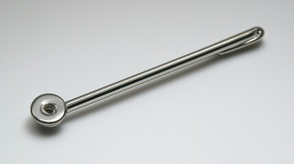 Polished stainless steel pipe tool on plain background