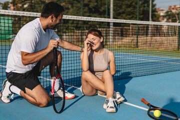 Young couple playing tennis outdoors enjoying a fun summer game