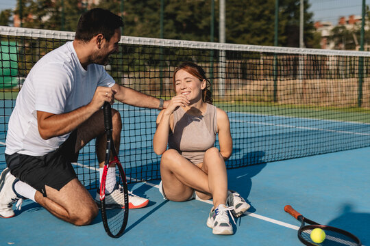Young couple playing tennis outdoors enjoying a fun summer game