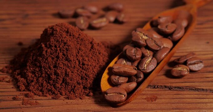 Arabica Coffee Beans Maragogipe on a Wooden Background with Rotating Effect. Elephant Beans with Ground Coffee