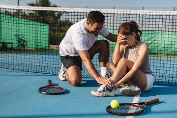 Young couple playing tennis outdoors enjoying a fun summer game