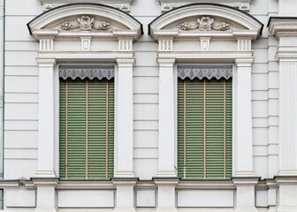 Beautiful old windows with closed shutters